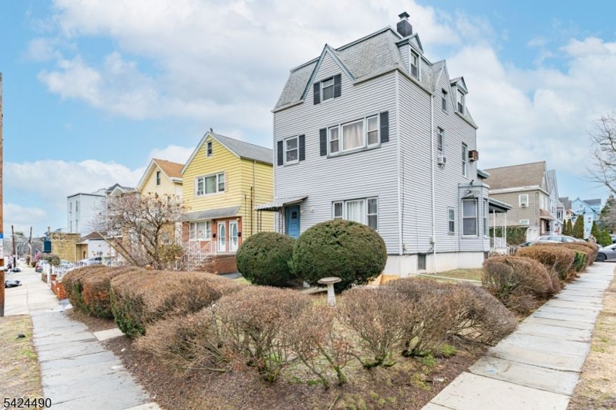 Well-kept three-family home offering approximately 3,400 sq ft of living space on a deep 43.91   126 lot. Interiors are bright and updated, featuring hardwood and parquet floors, modern ceiling fans, and generous natural light. Units include inviting living areas with bay-window seating, fireplaces, and clean, neutral finishes. Kitchens and baths are well-maintained, with a mix of white and dark cabinetry, tile backsplashes, updated vanities, and both tub and walk-in shower options. A partially finished basement adds flexible storage space. Strong curb appeal with gray siding, dormer windows, and manicured landscaping in a desirable Bayonne neighborhood.