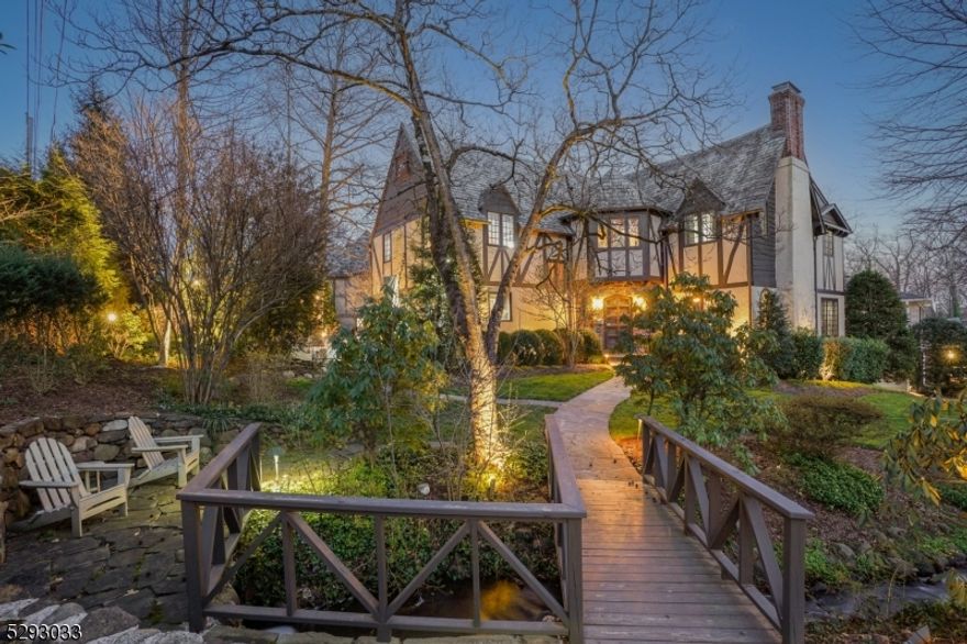 TRADITION MEETS LUXURY LIVING * Located on a quiet, tree-lined street (south, southwest facing) and replete with beautiful architectural details, this fabulous home has cosmopolitan appeal and has been completely renovated on every level. Cross the picturesque bridge and enter through the inviting foyer to find a beautiful staircase and gorgeous floors/woodwork throughout! You can host in the sun-filled living room w/ beamed ceiling, fireplace and arched windows; feast in the elegant dining room, or reflect in the renovated office/family room. State-of-the-art kitchen has custom cabinetry, ss appliances, island w/ marble counters & bar seating, adj laundry rm, powder rm & access fab entertaining patio. Four upstairs bedrooms, each with their own full bath, incld the generous primary suite w/ sitting area, WIC & luxurious spa-like bath: double vanity, soaking tub & glass steam shower. LL: rec room, mudroom, half bath and access to garages. Inviting neighborhood, CAC, underground sprinklers, Sonos-ready speakers, outdoor patio, extensive landscape lighting & generator, for peace of mind. The lush grounds are extremely private with mature trees and perennial gardens. Just blocks from top-rated Millburn schools, MMS (0.7 miles) & MHS with busing to Hartshorn Elementary. Easy access to the Short Hills station (0.7 miles) to speedily bring you home from NYC. This spectacular home is an architectural masterpiece in an A+ location! Welcome Home!