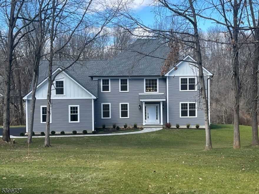 Introducing a stunning new construction home offering over 4,000 square feet of thoughtfully designed living space. This exceptional residence features 4 bedrooms and 3.5 baths, set on a 1.6 acre lot just minutes from downtown Chester.A dramatic two-story foyer welcomes you into an open, light-filled floor plan highlighted by soaring ceilings and elegant wide-plank hardwood floors throughout. The chef's kitchen is a true showpiece, featuring a large center island with Calacatta countertops and top-of-the-line BOSCH appliances. The space flows seamlessly into a sunlit eat-in area and an inviting family room with a cathedral ceiling and a cozy gas fireplace. Step out onto the deck off the kitchen perfect for outdoor dining and entertaining. Just off the foyer, a private study or home office with French doors provides an ideal work-from-home space. Upstairs, the expansive primary suite offers a walk-in closet and a spa-like bath with double vanities, a soaking tub, a stall shower, and elegant Calacatta countertops. Three additional bedrooms include one with an ensuite bath, along with a generous bonus room ideal for a game room, media space, or recreation area. Designer lighting from Chester Lighting enhances the home's sophisticated ambiance. Additional highlights include a heated three-car garage equipped with an electric vehicle charger. This exceptional property combines luxury, comfort, and modern convenience and is truly a must-see.