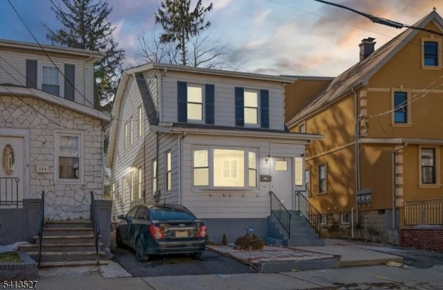 Situated on a quiet, tree-lined street, 106 Paine Ave is a beautifully maintained Colonial-style home that perfectly blends classic architectural charm with modern, move-in-ready convenience. This spacious one-family residence features a bright, open layout, highlighted by gleaming hardwood floors and an abundance of natural light. The heart of the home is the updated eat-in kitchen, which boasts sleek white cabinetry, a stylish tiled backsplash, and premium stainless steel appliances, all anchored by a functional breakfast bar and a generous pantry. Designed for modern living, the home is equipped with central air conditioning and multi-zone heating to ensure year-round comfort. The second level serves as a private sanctuary, housing three comfortable bedrooms and a full bath, while the main floor includes a convenient laundry area with a stackable washer and dryer. Beyond the primary living spaces, the walk-out basement offers immense potential for a home gym, workshop, or additional storage with easy ground-level access. Outside, the property features a dedicated driveway with parking for multiple vehicles. Ideally located in a highly walkable neighborhood, this home puts you just minutes away from local schools, shopping, and major commuter routes, offering the perfect balance of suburban tranquility and urban accessibility.