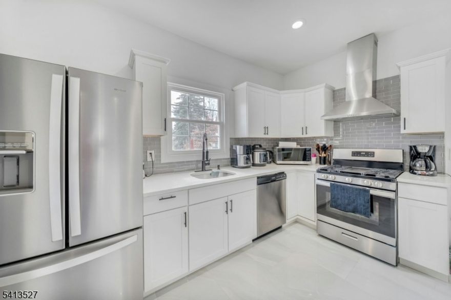 Situated on a quiet, tree-lined street, 106 Paine Ave is a beautifully maintained Colonial-style home that perfectly blends classic architectural charm with modern, move-in-ready convenience. This spacious one-family residence features a bright, open layout, highlighted by gleaming hardwood floors and an abundance of natural light. The heart of the home is the updated eat-in kitchen, which boasts sleek white cabinetry, a stylish tiled backsplash, and premium stainless steel appliances, all anchored by a functional breakfast bar and a generous pantry. Designed for modern living, the home is equipped with central air conditioning and multi-zone heating to ensure year-round comfort. The second level serves as a private sanctuary, housing three comfortable bedrooms and a full bath, while the main floor includes a convenient laundry area with a stackable washer and dryer. Beyond the primary living spaces, the walk-out basement offers immense potential for a home gym, workshop, or additional storage with easy ground-level access. Outside, the property features a dedicated driveway with parking for multiple vehicles. Ideally located in a highly walkable neighborhood, this home puts you just minutes away from local schools, shopping, and major commuter routes, offering the perfect balance of suburban tranquility and urban accessibility.