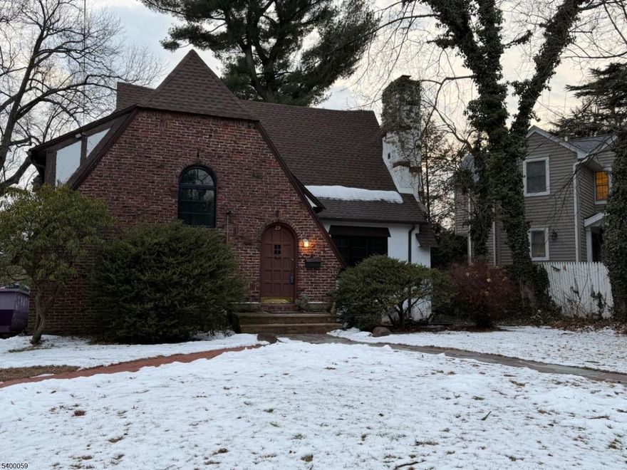 Charming Tudor with2 story Living Room; renovated kitchen and baths, freshly painted, quiet street. Close to train, stores, and high school.