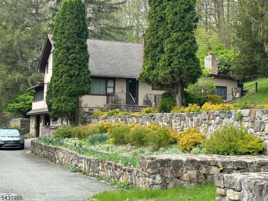 A little bit of county on the edge of town with 4+ Private and Serene acres that border the Historic Morris Canal, Numerous Flower and Herb Gardens with Artisan Stone Walls...Large Fenced Vegetable Garden...Short walking distance to NJ Transit Train Station, Centenary University that boasts the "Sitnik" Theatre with Live Performance's.  Center of Hackettstown offers Boutique Shopping, micro breweries, distillery and both Fine and Casual Dining to meet everyone's taste. Custom Built home is special for many reasons. 4 generously sized bedrooms, living room, family room w/Artisan Stone Wall/Fireplace, dining room, kitchen and a finished basement...Plenty of living space with a unique 19x20  3-season room with vaulted ceilings, skylights, ceiling fans. Schedule your showing today...this is one not to be missed!!
