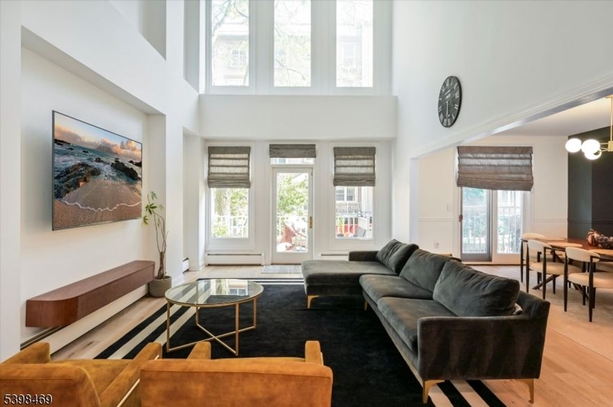 Discover refined living in this beautifully crafted 2,200 sq. ft. duplex condo in the sought-after Shearwater Court community of Port Liberte. This residence embodies upscale comfort with open interiors, abundant light, and timeless sophistication. The striking great room features soaring 18-ft cathedral ceilings that create openness and grandeur. Sunlight flows into the dining area and LR, while sliding doors lead to a private patio oasis, ideal for alfresco dining or mornings outdoors. The chef-inspired kitchen blends function and style with sleek finishes, ample cabinetry, and generous counter space to inspire culinary creativity. A convenient half bath is on the 1st level, perfect for entertaining. Upstairs, the primary suite offers a peaceful retreat with a spa-like en-suite bath and a versatile mezzanine, ideal as a reading nook or home office. Two addl BRs and a full bath complete the 2nd flr, providing privacy and comfort. This home includes central A/C, in-unit laundry, and access to Port Liberte resort-style amenities: 24-hr gated security, lap & infinity pools w/ skyline views, fitness ctr w/ saunas, tennis & basketball courts, dog runs, play areas, and waterfront promenades to Liberty State Park. Onsite conveniences include a dental office & Growing Seeds preschool. Easy NYC commute w/shuttle to Grove St PATH or ferry directly to Downtown NYC Pier 11. Minutes to highways, Holland Tunnel & Newark Liberty Intl Airport. Pets case by case.