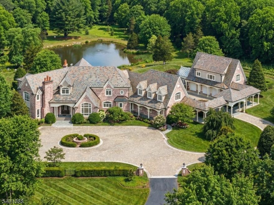 We are pleased to offer this exceptional and discreet luxury residence set on 217 acres in the heart of renowned Bedminster horse country. Beyond a gated entrance and along a one mile, scenic, tree-lined drive, Quisisana Farms offers a rare sense of privacy while remaining naturally connected to its pastoral surroundings. The custom manor spans three beautifully finished levels. The exterior showcases classic brick and limestone construction with a slate roof, while refined architectural details define the interior. A dramatic floating curved staircase introduces a sophisticated aesthetic featuring a two-story cherry-paneled library, elegant entertaining rooms, a media room, professional-grade kitchen, rich millwork, and four fireplaces. Upstairs, the primary suite offers a fireplace, formal dressing area, and bath. All bedrooms are en-suite. The lower level includes a substantial wine cellar, kitchenette, full bath, and flexible space for billiards, gym, and recreation. Outdoors, manicured gardens, stone terraces, 90 apple trees, and rolling lawns overlook a tranquil pond and waterfall, creating an inviting setting for both relaxation and entertaining. Additional amenities include, Creston Home System, a tennis court, climate-controlled greenhouse, expansive bluestone patio, and garage capacity for 4 vehicles with a heated motor court. A rare opportunity for those seeking refined luxury, exceptional privacy, and natural beauty without sacrificing scale, comfort, or elegance.