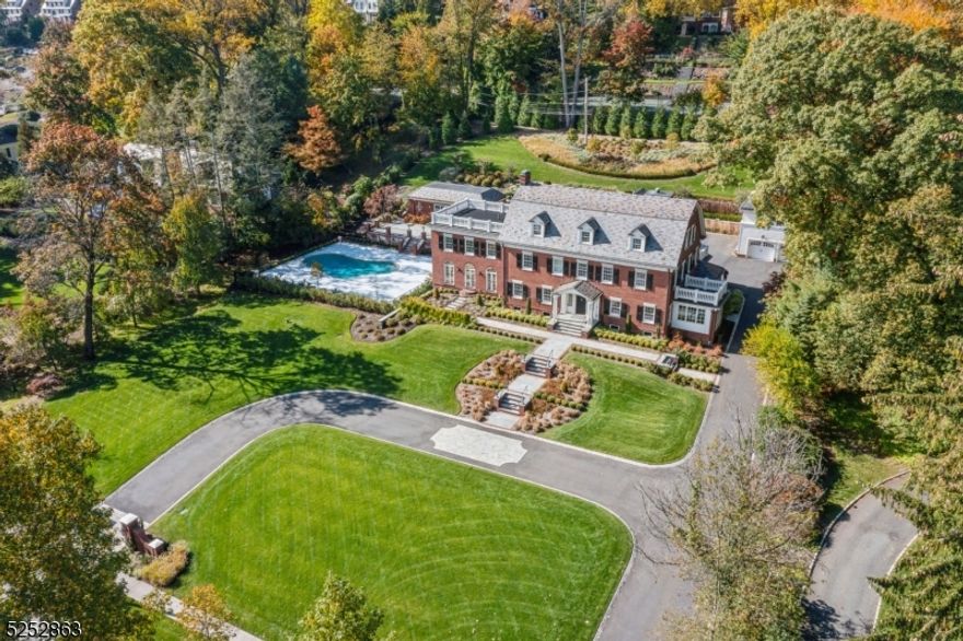 Elegantly sited in the Premier Estate Enclave of Montclair, an Iconic Georgian Colonial was built in 1924 completely renovated & re-engineered in 2019-2020. Centered on 1.45 acs of open, rolling resort-like property, its central location is close to vibrant restaurants & cultural venues. Every imaginable exterior, interior  mechanical renovation breathes new life into the classic estate,  enhanced by all recent hardscaping, landscaping, gunite pool w/marble pool decking, a cabana w/kitch & bath & updated 2-car detached garage w/expansive finished room above. Almost 7,000 sq ft on 3 levels plus 1,400+ sq ft lower level of decorator-inspired living spaces are served by recent elevator, while 7 bedrooms & 6 & 1 half baths provide ample privacy. The home's restoration places it firmly in the 21st century while paying homage to its traditional architecture. As a result, the bright, sunny floor plan integrates modern details & classical design elements throughout. Interior highlights are spacious rms, lux baths w/elevated design, floors of marble, wood, diff/tiles, gas fireplace; wide crown & baseboard molding; custom built-ins; French doors; recessed LED lights throughout, recent-complete electrical, plumbing & HVAC systems & generator serving whole property.. Approached by a circular paved drive, slightly elevated home is edged by formal landscaping & newly installed walkways. A rare opportunity with a coveted address, this Georgian Colonial Estate offers a resplendent lifestyle.