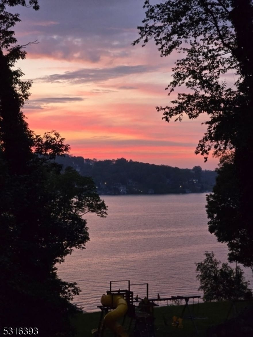 Majestic lake home many updates 5 Beds, 3 Baths, Garage, Main Lake, Deep Water, Sunsets, 1.675 Acres, 206 Ft Frontage, 2 lots per town records. 6 minutes from rt 80. Versatile Floorplan, Main level: Kitchen, Dining, 2 LR, Porch. First floor Bedroom & Full Bath, 2 FPs. Second level: 4 Beds, 2 Baths, Laundry & Full attic. Ground level: Great Room, Laundry, Utility, Wine Room, Door out to Spa & Patios. Garage with Attic Storage & Bunker. Parking for 10 plus Cars, City Sewer, Natural Gas, mini splits in each room. Original stone walls envelope the home, garage, highlight the property including the seawall, driveway, patios, staircases & gardens. Add your finishing touch, room for expansion, open porch with mini split, prepped to be enclosed, add a boathouse, pool & sport court. Lake area, beach & sandy swimming area, 2 docks w/lift & foundation where a 2-story boathouse once sat. Trees outline the side property for privacy, grand level yard by the water, playgrounds & kennel, space to do as you wish. Perennial gardens, patios, meandering walkways, room for outdoor living & hobbies. Summer activities right off the docks, swim, ski, fish, sail, row, kayak, power boats, personal watercraft, winter, skiing, sledding & skating. Updates: siding, roof, flooring, fresh paint, hardware, lighting, heating, mini splits, water system, full security system, alarm, & generator. FP & chimneys are sold as-is no known issues. Close to highways, public transportation, restaurants, shopping & spas.