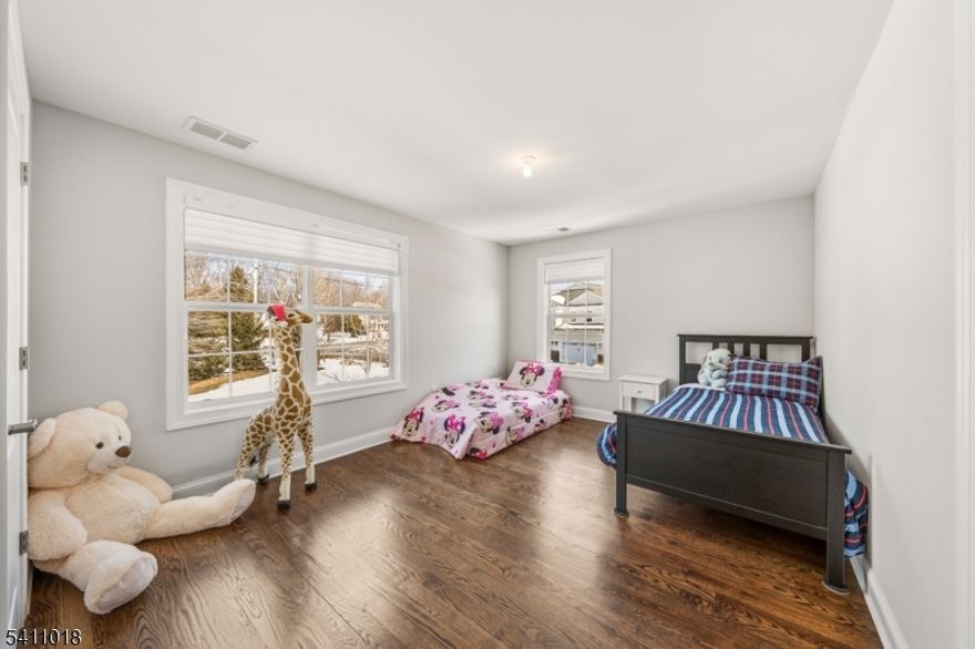 Welcome to this beautifully updated end-unit townhouse at Whippany Crossing, renovated in 2021 with premium upgrades throughout. Hardwood floors, crown molding, solid wood stairs with custom metal railings, and recessed lighting set the tone from the moment you enter. The main level features an open layout with a living room anchored by a gas fireplace, a gourmet kitchen with Jenn-Air appliances, center island, vented hood, floor-to-ceiling pantry, and a beverage station with under-counter cooler. A private office behind French doors, stylish half bath, dinette, and dining area complete the first floor. Upstairs, the primary suite offers two custom walk-in closets and a spa-like bath with dual vanities, freestanding tub, walk-in shower, and floor-to-ceiling tile. Two additional bedrooms, a princess suite, common bath, and a dedicated laundry room with custom cabinetry and utility sink round out the second level. Additional highlights include an EV charger port, upgraded electrical panel, water softening system, Hunter Douglas Silhouette blinds, basement rough-in plumbing, attached garage, deck, and sprinkler system. Minutes from Rts 24 & 287, shopping, dining, and just over 2 miles to the Morristown Train Station and Airport, this home stands out in all the best ways.