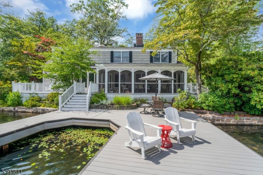 Tucked away in the quiet cove of New Jersey's cleanest glacial lake, just 31 miles from Midtown Manhattan, this exceptional lakefront property offers a rare opportunity to enjoy the coveted lifestyle of Green Pond's sought after Lake End Corporation. Architecturally distinctive and thoughtfully designed, this expansive 4-bedroom plus office, 3.5-bath home is perfectly positioned on a beautifully private lot. From the moment you arrive, you'll be drawn in by the peaceful setting, stunning lake views, and timeless charm. Inside, the home boasts a spacious layout ideal for both relaxed living and effortless entertaining. Special features include three gas fireplaces, a built-in wet bar, and a generous screened-in porch that invites you to unwind while taking in the water views. The finished, heated and air- conditioned bonus room above the oversized 3-car garage adds incredible flexibility. Perfect as a rec room, studio, or guest space. Step outside to your private dock, crafted from a Trex-like material for year-round enjoyment. Whether you're boating, swimming, or simply soaking in the scenery, this home offers direct access to all the priceless pleasures of lakefront living. Additional highlights include a built-in whole house generator for peace of mind and thoughtful updates throughout.