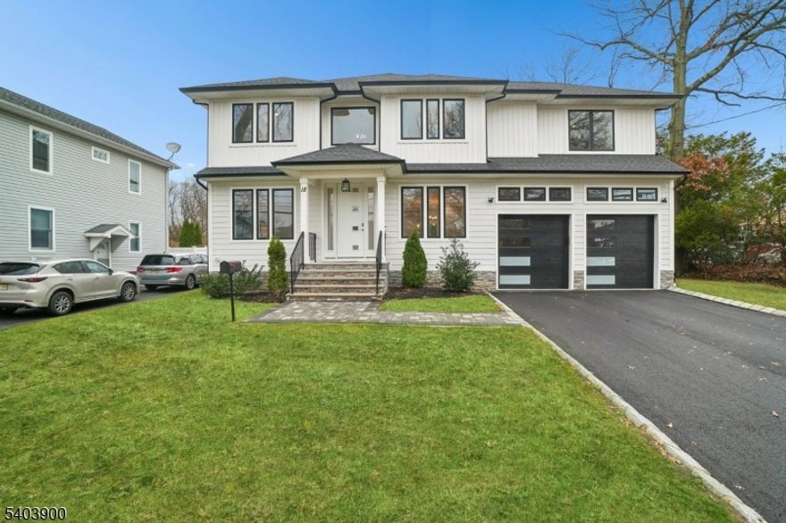 Experience the pinnacle of luxury living in this magnificent newer construction Colonial, offering over 4,700 sq ft of exquisite craftsmanship on 0.23+ acres. Built just two years ago, this home feels brand new and is perfectly situated in a prime Livingston location, moments from the town center, top-rated schools, shopping, dining, and the NYC bus. Step inside to an expansive open floor plan designed for modern entertaining. The heart of the home is the gourmet Chef's kitchen, equipped with high-end appliances, custom cabinetry, and a center island that flows seamlessly into the sun-drenched family room with a cozy fireplace. The first floor also features a dedicated office, a convenient mudroom, and a coveted first-floor suite. Upstairs, retreat to the luxurious primary suite featuring a spa-like bath and massive walk-in closets. This level also includes an additional ensuite bedroom, spacious secondary bedrooms, and a laundry room. The fully finished basement is an entertainer's dream, boasting a recreation room, wet bar, full bath, and a flexible 7th bedroom. With approx. 8 years of builder warranty remaining and low taxes, this home offers incredible value and peace of mind.