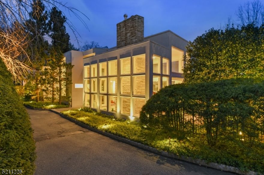 Sensational custom built contemporary with sparkling floor to ceiling windows and NYC views. Open and spacious floorplan with sunken living room with fireplace and Koi pond! Family room with fireplace adjoins updated kitchen. Primary bedroom suite with an amazing bathroom, walk-in closet and office with expansive deck complete the 2nd floor. Fantastic finished lower level with media and game room plus walk-out to pool, patios and bocce court. Extraordinary landscaping with unique specimen trees plus elaborate exterior lighting. One of a kind and special in every way. Not to be missed!