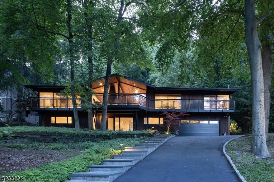 Exquisite, light filled Mid-Century Modern home located on one of the most coveted streets in Maplewood. This meticulously renovated 4 bedroom 2 full bath home provides luxury living at its best. With expansive floor-to-ceiling windows and beautifully set on a wooded lot backing to the South Mountain Reservation, this home offers all-season breathtaking views of the woods and the NYC skyline. As sunlight pours through the large floor-to-ceiling windows you are taken away to this tranquil and private oasis. The main level features wood floors, cathedral ceilings, a free standing wood burning fireplace in the striking living room. Spacious dining room, family room, renovated kitchen plus an oversized primary suite featuring cathedral ceiling, custom closets, fabulous bathroom plus  a stunning main level balcony with custom railing across front of home offers incredible entertaining and daily living. The lower level features a large foyer, two guest closets, three bedrooms and a renovated full bath. Heated 2 car garage with Tesla charging station. The patio and heated pool area are nestled in the Reservation offering unparalleled privacy and solitude.  Fireplace, chimney & flues in "as is" condition with no known issues.