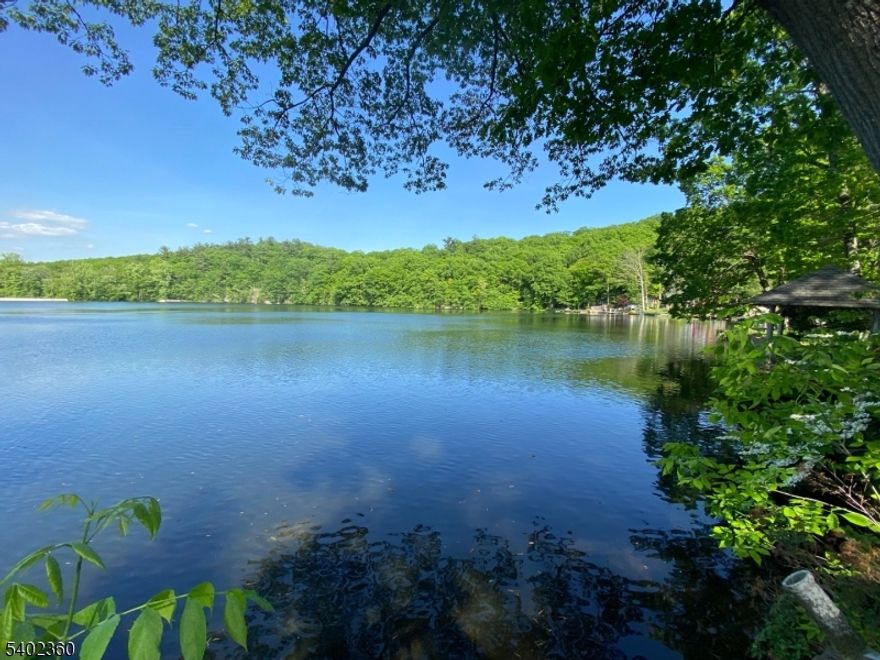 Beautiful lakefront home on Mount Glen Lake! This charming 3-bedroom home offers stunning water views and a spacious layout featuring  LIVINGROOM and dining room combination with soaring ceilings and a cozy stone fireplace.  The kitchen includes new countertops, new dishwasher, new windows and a large pantry for plenty of storage. Many of the windows are new in the home.  The main level opens to a large deck overlooking the lake- perfect for enjoying peaceful mornings, sunsets or entertaining guests.  With two bathrooms located on separate levels, the home offers convenance and flexibility. Step outside to newly installed steps leading down to a private lakefront deck right on the water. Situated on approximately 1/3 acre, the property also features a long driveway with parking for up to 10 cars. Septic is a TWO bedroom septic as per the health dept- tax dept has this home as 3 bedroom home