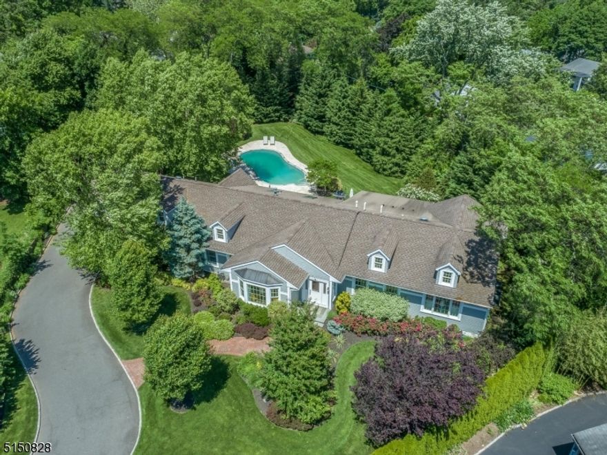 A breath of fresh air! Stunning, "smart," and sophisticated 5 bedroom, 4 full bath contemporary home located on a private cul-de-sac in desirable Upper Montclair. True one-floor living stylishly renovated with a clean and discerning eye to space and natural light. Elegantly designed with an open flow perfect for every day living and entertaining. A cascade of light guides you immediately through the spacious living and dining areas highlighted by a double-sided gas fpl, into the modern, clean lined kitchen precisely designed with form and function in mind. This chef's kitchen is fully open to the adjacent family room. Imagine a glorious gathering space overlooking the expansive backyard beautifully landscaped with newly resurfaced salt water pool, patio and hot tub, an elegant, fun and relaxing oasis of your own. It's a view enjoyed by nearly every room bringing the "outside in." The primary ensuite bedroom is a serene get-away featuring a gas fpl, large walk-in closet w/custom built-ins and spa-like bathroom. 2 additional bedrooms (one ensuite) and hall bath complete the south wing. Guests/nanny suite in the north wing + an additional bedroom perfect for a home office. The finished basement offers a large rec area and home gym. Convenient oversized attached two-car garage w/an EV charger connection and pull down stairs to large attic space. And yes, this house is "smart!" Control the lights, security, entertainment center all from you smart phone. A simply beautiful home.