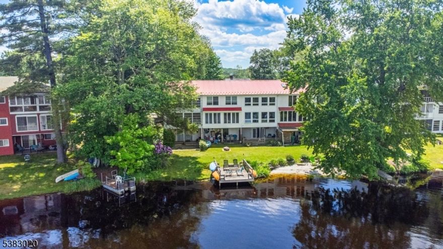 Welcome to your lakeside retreat! This approx. 1520 sq. ft. townhouse offers the perfect mix of comfort, convenience, and flexibility.  Inside, the sun -filled open layout is highlighted by a modern bioethanol decorative fireplace that adds warmth and style,and a beautiful view of the High Point Monument! The kitchen has granite countertops with SS appliances and upstairs,you'll find two large bedrooms that were originally designed as three, providing an option to reconfigure if desired. Step outside to your private dock and sandy beach, or relax on the covered deck overlooking the water.  The home also boasts a fully finished walk out basement that is ideal for entertaining, additional living space or possible mother-daughter accommodations. Located close to Mountain Creek Resort for skiing and approx. 10 minutes from major shopping! This property offers four season enjoyment-from summer boating and swimming to winter skiing and snowboarding. Very low taxes!  .....Aprox 10 mins from Train Station - and Bus Stop.....