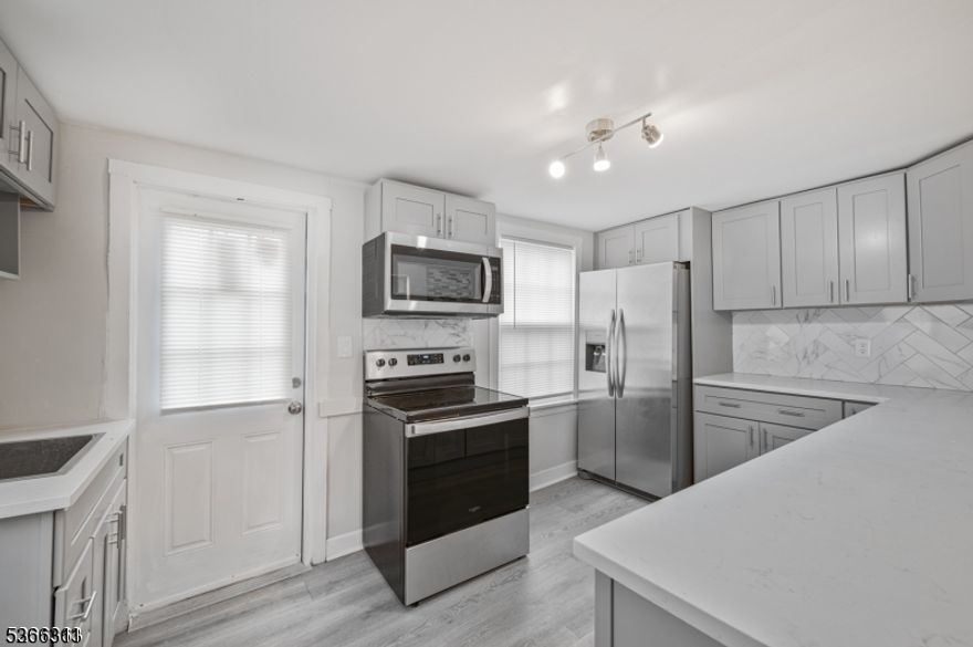 Stunning Partly Furnished 5-BR Waterfront Rental FEATURING TWO SEPARATE UNITS!  Beautifully renovated home and move-in ready, this unique riverfront home offers two fully independent units.  Each unit has its own private entrance, full kitchen, and living room, all professionally closed off for privacy. A shared main entry is also available for flexible use. The first floor includes two open-concept kitchens with quartz countertops and stainless-steel appliances, two separate living rooms, a dining area, and a full bath. The second floor offers five well-sized bedrooms, two updated full baths, a storage room, and a walk-up attic. Enjoy new flooring throughout, central air, and a high-efficiency heat pump system. Large windows overlook the South Branch of the Raritan River with direct access to kayaking and fishing. Conveniently located near the Columbia Trail, shops, restaurants, and major routes. A rare rental offering ideal for shared living, or live-work arrangements.