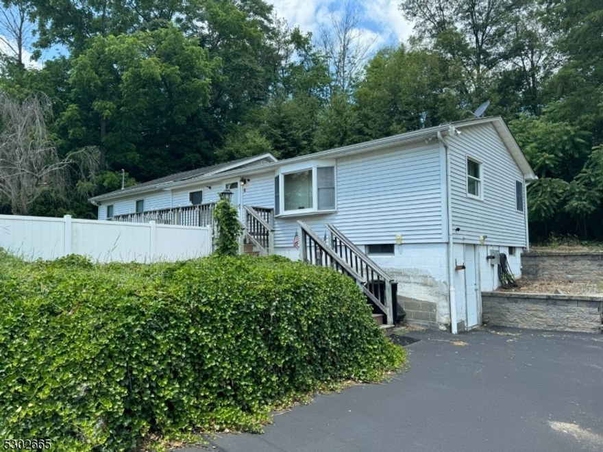 Spacious 3 bedroom ranch situated on a corner lot in Lake Neepaulin, Formal living room, kitchen with breakfast bar and separate dining area.  Large primary bedroom with walk in closet and unfinished space for a future full bath. Partial walkout basement with laundry and doggie wash station.