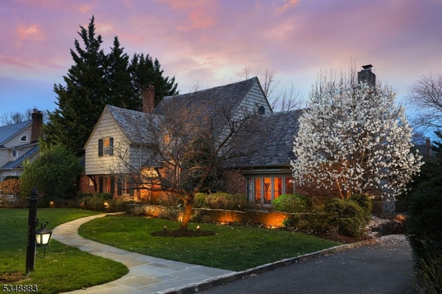 Located in the highly sought-after Gardens section of Westfield, this exceptional Tudor blends timeless craftsmanship w/modern luxury. Featuring stunning architectural details such as arched doorways, custom woodworking & beamed ceilings, this home offers both charm & elegance throughout. The main level includes a living rm which boasts a soaring beamed ceiling & striking floor-to-ceiling stone wall w/wood-burning fplc and a formal dining rm w/access to an outdoor porch perfect for entertaining. The kitchen boasts a large island breakfast bar, granite countertops, SS appliances & eating area which flows seamlessly into the family rm.  Off the breakfast rm you have access to a flagstone open porch, ideal for outdoor relaxation. A potential 5th bdrmm/office w/wood-burning fplc, full bath & powder rm complete this level. The 2nd flr offers a primary suite, featuring a spacious WIC & private bath w/his & her vanities & oversized stall shower. 2 additional bedrooms, a hall bath & laundry complete this level. The 3rd floor offers a private bedroom w/full bath, perfect for privacy or as a guest suite. The finished LL expands the living space w/a generous rec room, exercise room, full bath and spa room w/steam shower and jetted hot tub. Outside, beautifully landscaped grounds surround the home & the oversized two-car garage offers plenty of storage plus a generator. Conveniently located near shopping, dining & NYC trans, this home is truly a gem, offering both style & practicality.