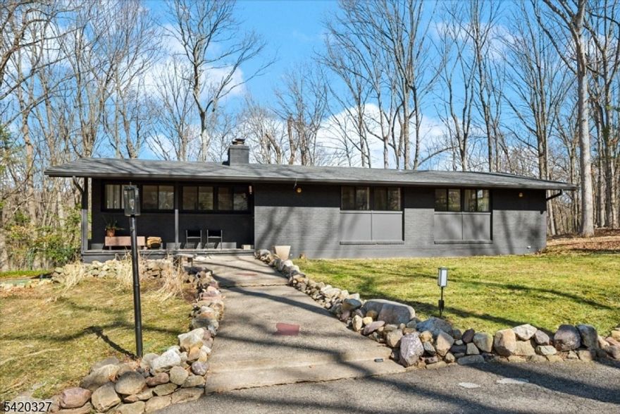 Mid-Century Modern Gem on a Corner Lot in Denville. Welcome to 2 Audubon Dr, a beautifully updated Mid-Century Modern Ranch set on a desirable corner lot in one of Denville's sought-after neighborhoods. This distinctive home blends timeless architecture with modern updates, offering 4 bedrooms, 3.5 baths, 2-car garage, circular driveway, and a versatile layout across two finished levels.The main level showcases an expansive living room with a striking fireplace, walls of windows that flood the space with natural light, and a seamless flow into the kitchen area. The updated kitchen features sleek cabinetry, generous counter space, and direct access to a private deck, ideal for indoor-outdoor entertaining. The primary suite offers a full bath and a walk-in closet, complemented by two additional bedrooms and a full hall bath. The walkout lower level offers exceptional flexibility with a spacious family room, recreation area, additional bedroom, full bath, and convenient half bath, perfect for guests, or work-from-home.. A dedicated laundry area, utility space, and garage access add convenience.Additional highlights include hardwood floors, recessed lighting, a 2-car garage, and multiple outdoor areas to enjoy the natural surroundings. Ideally located near parks, top-rated schools, shopping, dining, charming Denville downtown, and major highways, this home offers both privacy and convenience in the heart of Denville.