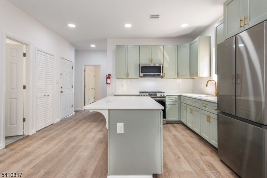 Welcome to 64 Grace Street, a thoughtfully designed apartment offering modern finishes, privacy, and convenience without the feel of a large apartment building. This spacious approximately 1,000 sq. ft. 2-bedroom, 2-bath residence is ideal for those seeking a well-kept, turnkey home. The apartment is accessed via a short flight of steps from the sidewalk, providing a sense of separation and quiet while offering first-level living once inside. The open-concept layout creates a natural flow between living, dining, and kitchen spaces, making the home both functional and inviting. Features include luxury vinyl plank flooring throughout, central air conditioning, and forced hot air heat for year-round comfort. The kitchen is well appointed with Samsung stainless steel appliances, quartz countertops, soft-close shaker cabinetry, and a designer tile backsplash. Laundry hookups are available (washer and dryer not included). The primary bedroom includes a private full bath, while the second bedroom offers flexibility for guests or a home office. On-street parking is available. Pets may be considered with restrictions. Conveniently located just a few blocks from the Irvington Bus Terminal and close to the Garden State Parkway, NJ Turnpike, and Route 78, with easy access to Newark, Jersey City, and Manhattan. Nearby dining, shopping, Downtown Newark, Maplewood, and Irvington Park with walking paths and recreation are all close by.