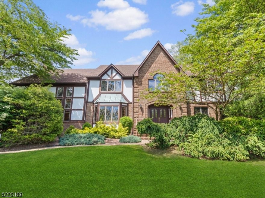 Fantastic Tudor style colonial in desirable Gentry Estates!  Fabulous privacy with level lot and mature landscape lead to covered front porch and welcoming foyer.  Neutral decor, very generous room sizes and fantastic flow make this the perfect home for living and entertaining!  Impressive great room features wood burning fireplace, wet bar and spiral staircase to loft above, as well as floor to ceiling windows for natural lighting.  Chef's delight eat-in kitchen offers stainless steel appliances, enormous breakfast area and many options for reconfiguration.  Formal living room with fireplace and dining room with ample space for large gatherings.  Also on the first floor a home office, laundry room, powder room.  Numerous sliders and doors to composite deck with built-in lighting for additional outdoor living space.  Second floor includes high ceilings, a primary suite with luxurious bath and 2 walk-in closets, 3 additional bedrooms, loft area off primary suite and main bath with double vanity and tub/shower.  Full heated unfinished basement with high ceilings, oversized garage, attic storage, central vacuum, generator hookup, 6 zone heating, 2 zone air conditioning and more make this home a great choice!  Long Valley schools and West Morris Central High School with IB program.