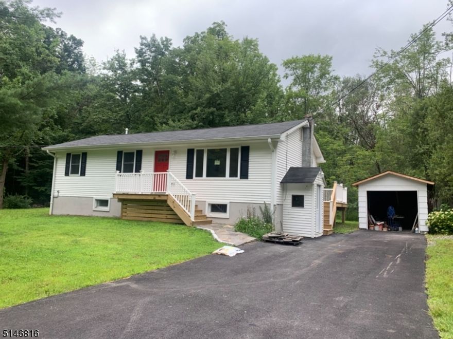 Completely remodeled from the studs up. Country living on over an acre in Crandon Lakes. Everything new including new walkway, painted front door, newer vinyl siding, gutters, a new roof, new windows, a new well head, new electrical, new plumbing, central AC, new sliding door, electric hot water heater, back deck , front porch and brand new septic! Kitchen has SS appliances with soft close cabinets, center island w/ butcher block top, new paved driveway, new tiled floor in basement, slider to back deck off DR.  1/2 bath and laundry in basement along with a den/office.  Come see what Crandon Lake has to offer- 2 beaches, boating, fishing, pavilion, bb field, play ground and picnic area!