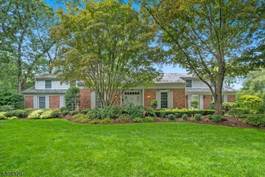 An elegant Upper Montclair custom home offering refined living and exceptional scale, set on a lushly landscaped three-quarter-acre property designed for both grand entertaining and everyday comfort. This impressive residence features four expansive three-room bedroom suites, including a luxurious first-floor primary suite, along with an additional ground-floor bedroom ideal for guests. Six beautifully updated full baths and two thoughtfully placed powder rooms provide effortless convenience throughout the home. Generous, light-filled rooms define the main level, including a large eat-in kitchen, richly appointed library, private office, formal living room with gas fireplace, and elegant dining room each designed with timeless proportions and seamless flow. The fully finished lower level is a destination of its own, featuring a spacious family room with fireplace, second kitchen, gym, bedroom, two full baths, and a temperature-controlled wine cellar perfect for recreation, relaxation, or hosting. Outdoors, the private grounds unfold into a resort-style retreat with manicured gardens, stone patios, a custom in-ground pool with cascading waterfall, and an inviting firepit, creating a tranquil setting for gatherings or quiet moments alike. A rare offering that blends classic architecture, modern amenities, and a truly exceptional lifestyle all close to Yantacaw Brook, Brookdale, Tuers Parks. Upper Montclair Village. restaurants + shops are close by.