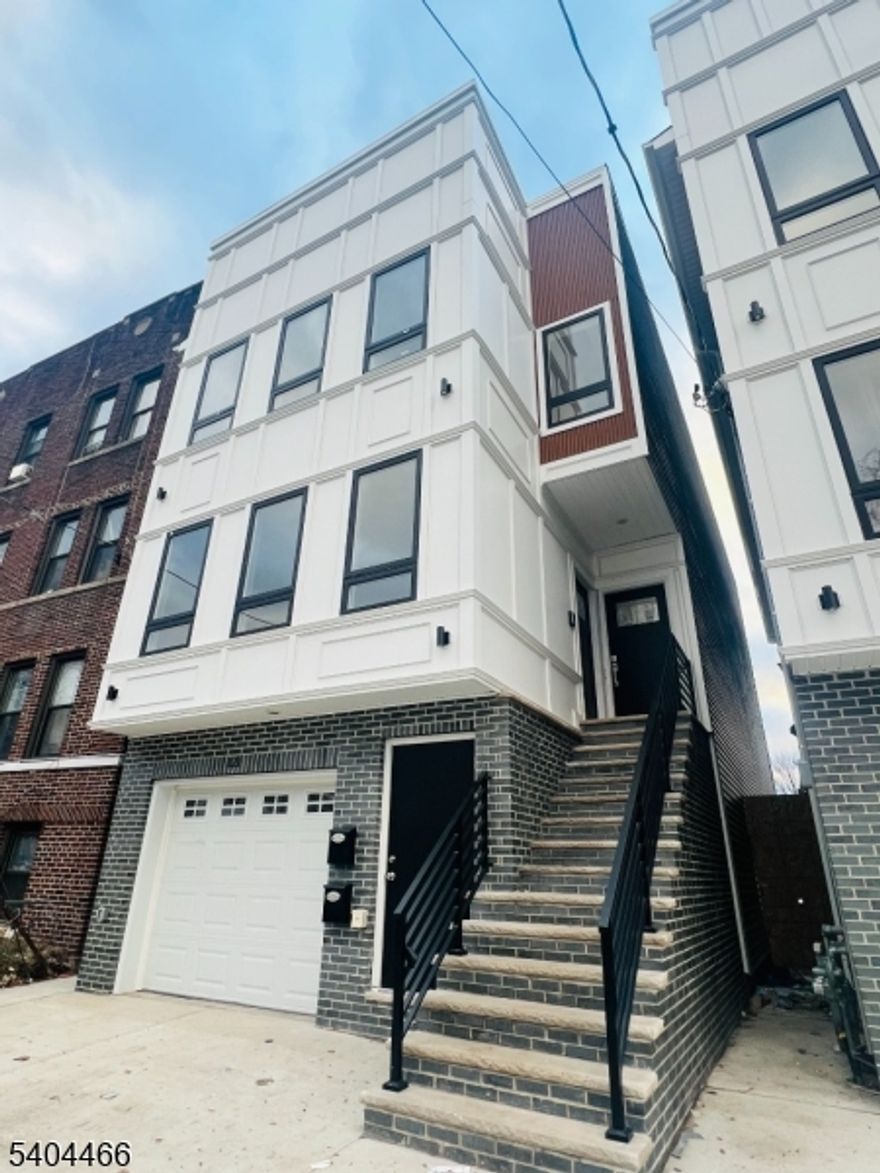 Be the first to live in this newly constructed 3-bedroom, 2-bath Unit 2 at 121 Osborne Ter. This sun-filled second-floor home offers a spacious open-concept layout with high/vaulted ceilings, recessed lighting, and gleaming hardwood floors throughout. The designer kitchen is loaded with upgrades oversized island with abundant storage, quartz counters, custom cabinetry, French door refrigerator, gas range, built-in microwave, and dishwasher. Enjoy the convenience of in-unit washer/dryer plus central heat and A/C. The primary suite features a private ensuite bath and a true walk-in closet. Both bathrooms feel like a spa, featuring bold tilework, LED backlit mirror, glass-enclosed shower, and modern gold-toned fixtures.  A must-see new construction rental schedule your private tour today!