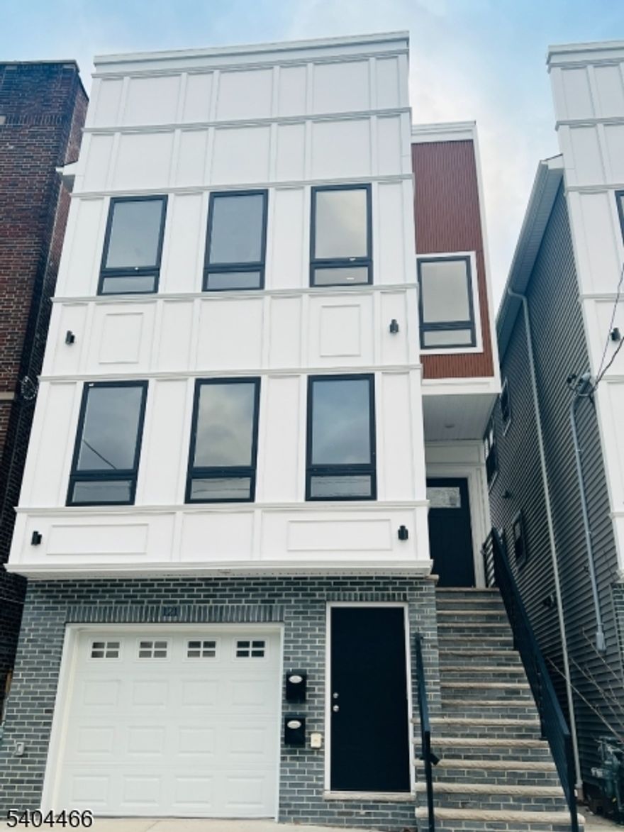 Be the first to live in this newly constructed 3-bedroom, 2-bath Unit 2 at 121 Osborne Ter. This sun-filled second-floor home offers a spacious open-concept layout with high/vaulted ceilings, recessed lighting, and gleaming hardwood floors throughout. The designer kitchen is loaded with upgrades oversized island with abundant storage, quartz counters, custom cabinetry, French door refrigerator, gas range, built-in microwave, and dishwasher. Enjoy the convenience of in-unit washer/dryer plus central heat and A/C. The primary suite features a private ensuite bath and a true walk-in closet. Both bathrooms feel like a spa, featuring bold tilework, LED backlit mirror, glass-enclosed shower, and modern gold-toned fixtures. Generous additional bedrooms and backyard access complete the package. A must-see new construction rental schedule your private tour today!