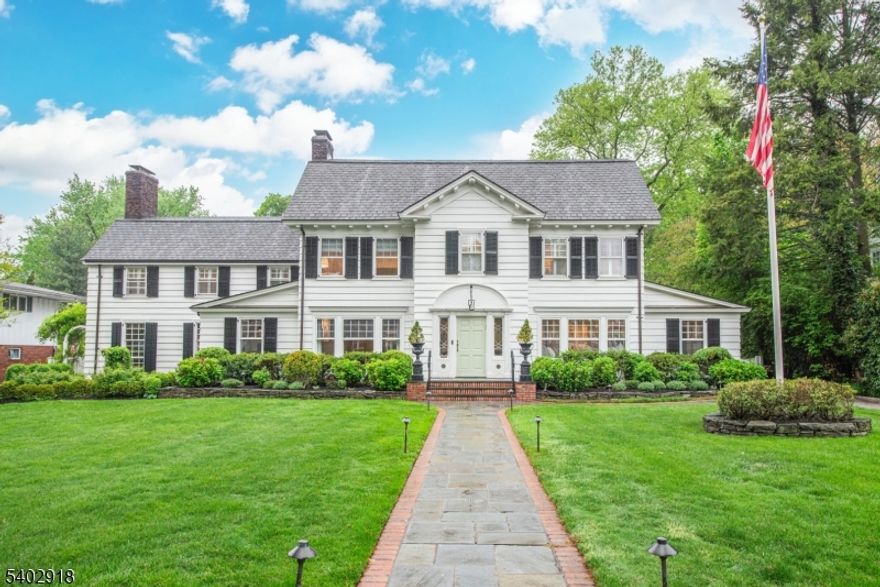 Welcome to one of Glen Ridge's most spectacular homes. This unique Colonial set on an acre of flat lawn (ideal for pool and tennis court) boasts 6,000 sq ft and is located steps away from coveted Glen Ridge schools, Montclair restaurants and commuter train stations. With 3 large living rooms, 6 bedrooms, 4 baths, and 2 powder rooms, the estate-like home combines lux living and elegant entertainment space. Chef-style kitchen with large island, Wolf double ovens, Wolf 6-burner gas range, Sub-Zero fridge, drink and wine fridge, butler pantry AND adjoining playroom/eating space. One light-drenched family room overlooks backyard and features custom millwork and massive ceilings. Another boasts mahogany walls and coffered ceilings, lodge-style gas FP, and magnificent bar w/ matching stools. The spectacular dining room features enclave shelving, custom window seat, and grand layout perfect for entertaining. Add'l 1st floor rooms include formal living room w/ FP, mudroom, powder room and office. Head up the newly carpeted front or back staircase to the second floor, featuring 5 spacious bedrooms, including primary suite w/ wood-burning FP and gorgeous marble bathroom w/ oversized tub, another bedroom w/ en-suite bath, and another w/ newly installed solarium/playroom. The 3rd floor hosts large bedroom, full bath and spacious laundry and storage room. Two finished basements provide versatile space: one w/ pool table and (fourth) FP; the other w/ playroom, wine cellar, and powder room.