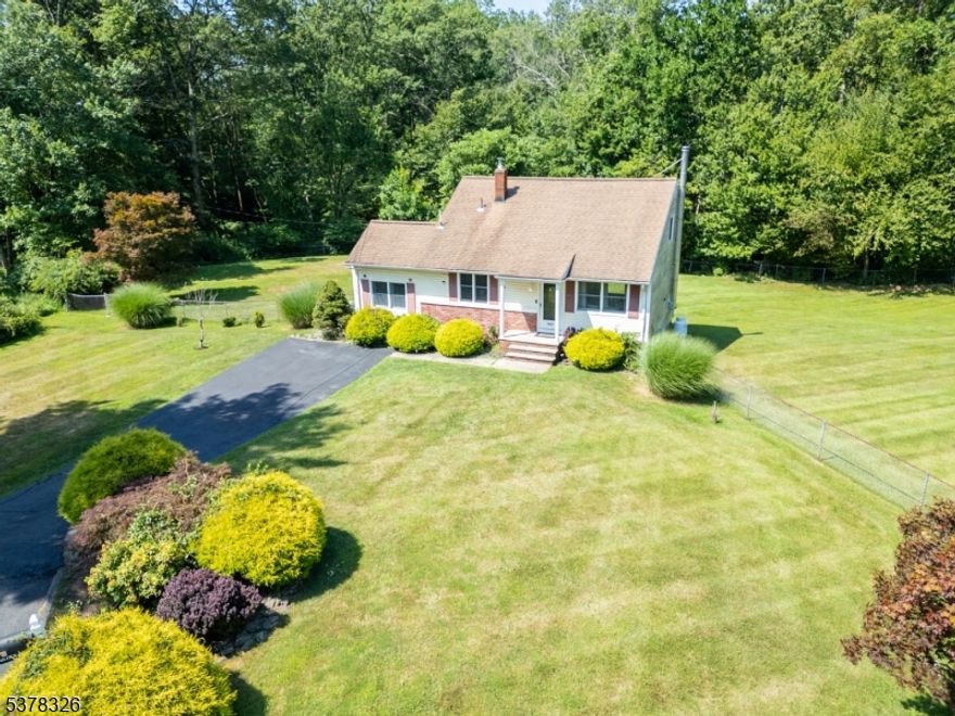 Spacious & Updated 3BR/2BA Split-Level in Desirable Randolph! Nestled on a .69 acre, park like corner lot, this home offers a fully fenced, level yard backing to woods for added privacy. The updated kitchen boasts refinished cabinetry, granite countertops, a breakfast bar, and stainless steel appliances, while beautiful refinished hardwood floors flow throughout. The lower level features a bedroom, full bath, and a family room with a dry bar. Upstairs, you'll find the primary bedroom, another generously sized bedroom, and an additional full bath. The partially finished basement provides extra recreation space. Enjoy nearby Brundage Park's 232 acres of amenities, including tennis courts, sports fields, trails, playgrounds, and more. Conveniently located near Rt 10 for quick access to shopping, dining, and commuting. Recently converted to natural gas.