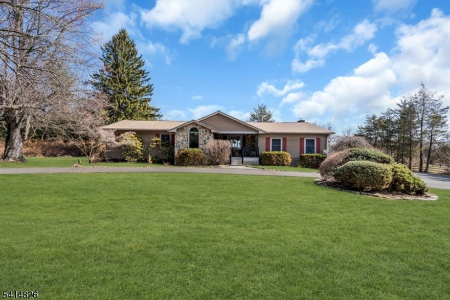 Beautiful 3-bedroom custom ranch in the highly sought-after Tewksbury Township, nestled on nearly 4 serene acres. This thoughtfully designed home features a 2-stall barn with a tack room, a granite kitchen with stainless appliances and cherry cabinets, and a sunken great room with beamed, cathedral ceilings that create a dramatic, open feel. Four full baths throughout the property ensure convenience and privacy for everyone! The finished basement offers three separate rooms perfect for guests, a nanny area, or dedicated flex space. Updates abound: new roof in 2023, new 4-bedroom septic in 2022, Anderson sliders to the deck in 2024, and landscape hardscaping and walkway completed in 2022, plus many additional improvements to enhance comfort and curb appeal. A whole-house generator provides peace of mind, and the paved, circular driveway adds to the property's stately entrance. Additional highlights include abundant natural light, a seamless flow for entertaining, and ample yard space for outdoor activities, gardening, or future expansion. This is an exceptional opportunity to own a meticulously cared-for home in a premier rural enclave with easy access to amenities, shopping, and commuting routes. Schedule your private tour to experience the charm, craftsmanship, and lifestyle this home offers.