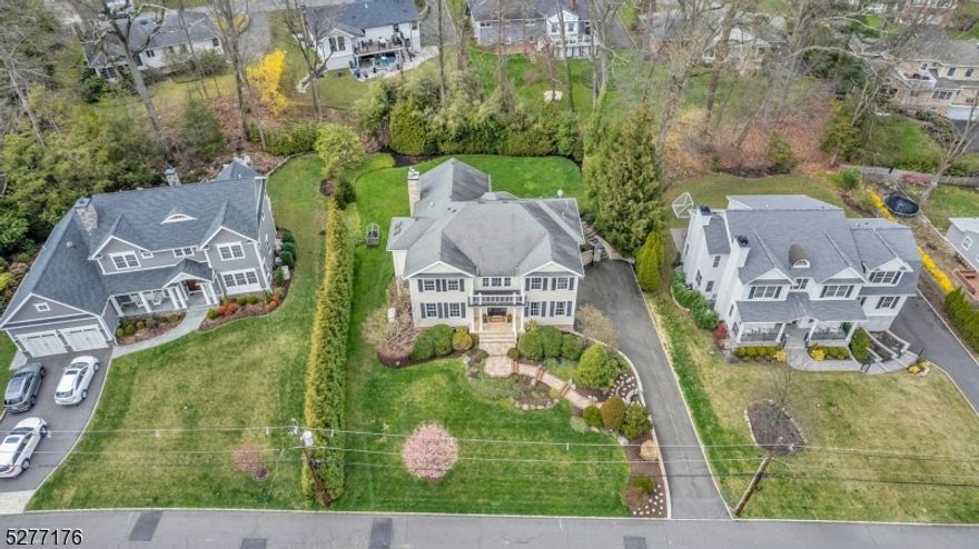 Stunning newer Colonial located in Summit's Northside and Lincoln-Hubbard School district, ranked #1 in NJ by US News & World Report. Boasting a grand 2-story foyer, this fine home welcomes you with 10-ft ceilings and an expansive open floorplan. Enjoy radiant heated floors, ensuring warmth and comfort through the cooler months. The gourmet kitchen has SieMatic cabinetry, a center island, and top-of-the-line appliances including a SubZero fridge/freezer, 6-burner Viking Range, Miele dishwasher and Marvel wine fridge. Completed with marble counters and backsplash, the Kitchen is a delight for any discerning chef. Seamlessly blending indoor-outdoor living, French doors from the kitchen open to a private backyard, ideal for entertaining or unwinding. The adjoining family room, with its gas fireplace and large bay window, offers a welcoming retreat. Elegance extends to the upper level where a luxurious primary suite awaits, complete with a sitting room, which is also a possible additional bedroom, two walk-in closets, and a spa-like primary bath featuring a jetted tub and shower. Three additional bedrooms and two baths provide ample additional space. The lower level includes a recreation room, possible au pair quarters with a full bath, gym, and mudroom with access to a 3-car garage with convenient NewAge wall cabinets. Additional features include a built-in generator, 3 zones of central AC and built-in speakers. Welcome home to a world of refined luxury in a premier location.