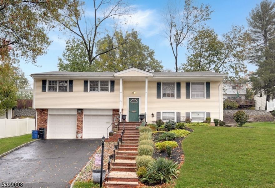 Fabulous oversized bi level features 4 bedrooms 3 full baths and an oversized 2 car garage.   Immaculate /privacy backyard.  Walk to NYC transportation and houses of worship.