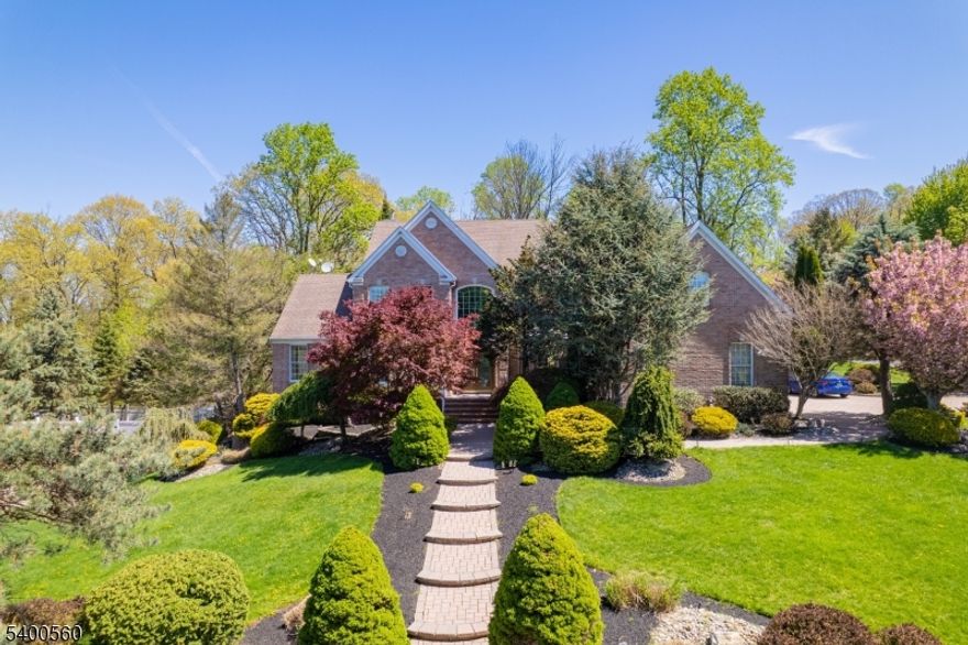 Welcome to "Top of the World" one of Green Brook's most coveted communities! Situated on a premium 0.64-acre corner lot, this stately 3,986 sq. ft. residence perfectly blends expansive living spaces with elegant outdoor transitions. The curb appeal is immediate, featuring professional landscaping, a sweeping paver driveway, and matching paver walkways that lead to a grand entrance. Inside, the home has been freshly painted in a neutral palette, highlighting the bright and airy floor plan. The main level offers both a formal living room and dining room, flowing seamlessly into a magnificent Great Room anchored by a cozy fireplace. The heart of the home is the expansive, light-filled sunroom, a true retreat for relaxation or hosting guests year-round. With 5 spacious bedrooms and 3.5 bathrooms, there is ample room and a dedicated home office. The master suite serves as a private sanctuary, while the additional bedrooms offer generous closet space. The massive walk-out basement provides endless possibilities for a home gym, media room, or play area, stepping directly out to a private paver patio and a level yard. Practicality meets luxury with a 3-car garage and a location that is second to none. Enjoy the peace of a quiet suburban enclave while being just minutes away from downtown Warren's premier shopping, fine dining, and entertainment. This is more than a home; it's a lifestyle upgrade in a top-tier community. Your search ends at 19 Ridge Road!