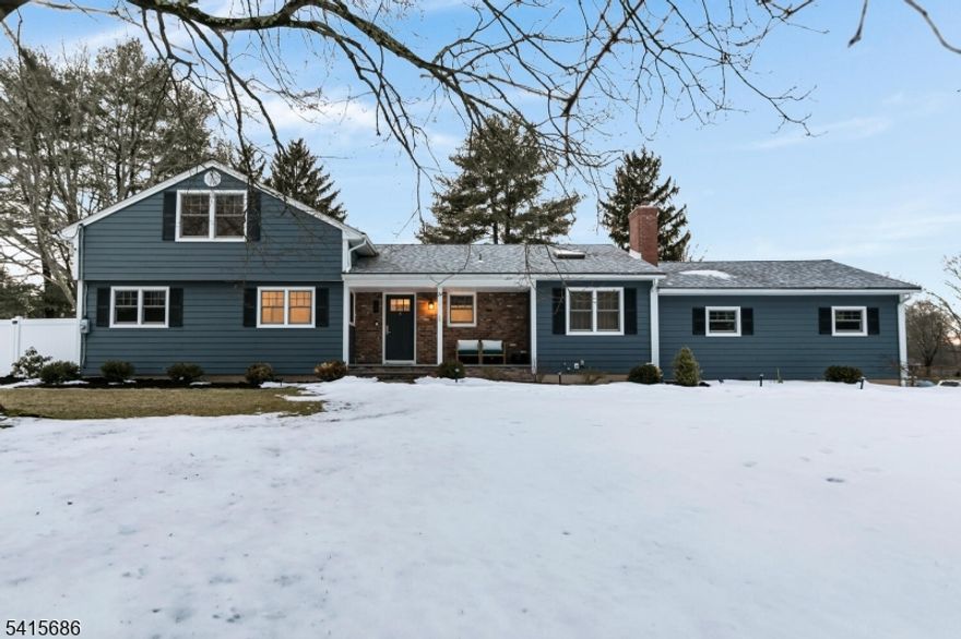 This beautifully renovated expanded 5-bedroom ranch is nestled on nearly an acre in a quiet, desirable neighborhood. This home offers exceptional privacy and entertainment space with a fully fenced backyard featuring a large deck, patio and a sparkling saltwater pool. Inside, the bright, interior offers abundant natural light, refinished hardwood floors, tall ceilings, and a cozy family room with a brick woodburning fireplace. The fully remodeled kitchen is a standout, featuring custom cabinetry, marble countertops, a large waterfall island with seating, high-end built-in appliances including a premium Dacor refrigerator, ideal for everyday meals. Enjoy gatherings in the living room and adjacent dining room which offers direct access to the deck and kitchen. The first-floor primary bedroom is spacious with a luxurious master bath extension and built-in wardrobe. All bathrooms were updated and boast modern finishes with the main bath featuring a freestanding soaking tub. Other improvements (2021-2023) include a new roof, front and patio doors, complete recessed lighting throughout, refinished floors, carpets replaced, new fence, paver walkway, and water filtration system. A partially finished basement includes a rec room, ample storage,  and workout area. Move-in ready and meticulously updated, this wonderful home is conveniently close to shopping, parks, restaurants, and transportation in a top NJ school district offering the perfect blend of comfort, style, and location.
