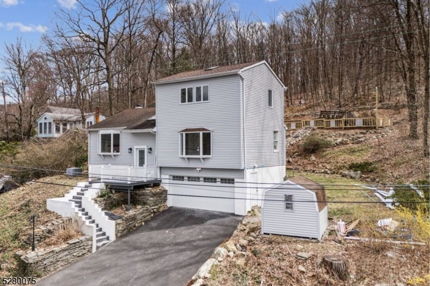 Stunning fully renovated, bright & sunny, large single-family home in Lake Hopatcong with year-round lake views! Located in Brights Cove at the north end of Lake Hopatcong, enjoy all the conveniences of urban living in a lake-like setting. Just minutes to dozens of restaurants including eight waterfront options and over a dozen marinas, allowing you to dock and store your boat. This home is complete with a top-floor primary bedroom with a 5-piece en-suite, walk-in closet, washer/dryer, fireplace, and skylights. 2 additional bedrooms on the main floor with a shared full bath, beautiful cooks kitchen/dining room combo, separate den/study with vaulted ceilings and skylights, large family room with fireplace, cozy finished basement with a pellet stove, a bonus/flex room for a guest room, office, etc., a 3rd full bathroom and access to the 2-car garage; also, ample off-street parking (a rare find in the lake community). Elegant and modern living in this custom lake home with upgraded NEW appliances, recessed lighting, and skylights. Close to multiple grocery stores, shopping, trains to New York, Route 80, and top-rated schools. Move right in and live the lake life year-round at New Jersey's largest freshwater lake offering residents & visitors outstanding boating, sailing, kayaking, swimming, fishing, water sports & more!