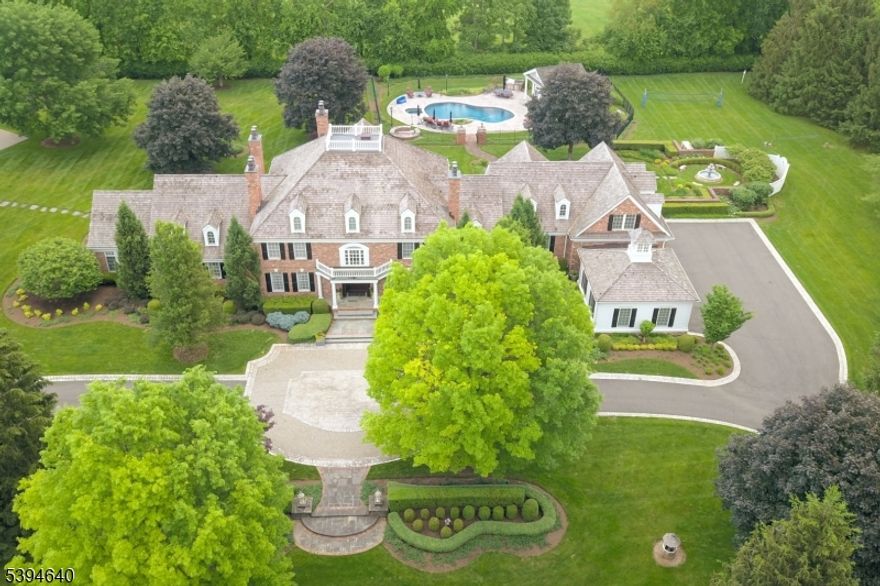 Once in a lifetime opportunity to live the Dream! This impeccable ALL BRICK GEORGIAN COLONIAL ESTATE sits on 5 totally level acres surrounded by mature trees with extensive landscaping for extraordinary privacy. Built in 1991 on a quiet street in bucolic Mendham Township, the property has had over 3 million dollars in additions, replacements + renovations by the current owners. There is nearly 13,000 square feet of interior space with incredible amenities including stunning heated pool + pool house, tennis court, climate controlled barn, golf simulator, state of the art home theatre, 600 sq ft home gym, sauna, 900 bottle cherry wine cellar + game room. The house has high ceilings, custom cabinetry, 5 fireplaces, 6 bedrooms with 2 Luxurious Primary Suites, one on the 1st floor, two offices, 2 laundry rooms + easy 1st floor access to 5 car attached garage new in 2016. Creston automation, LED lighting and Fine Art Lamps handcrafted throughout the house. Outdoors the gated property features a level property, garden, fountain, summer kitchen, electric dog fence fire pit, a 30 KW generator to ensure luxurious living is uninterrupted! Your dream home is suited for great living and offers everything a discerning buyer who values the ultimate in luxury living would want! Can be sold fully furnished. US News & World Report ranked Mendham Middle & Elementary Schools 3rd & 4th in New Jersey respectively.