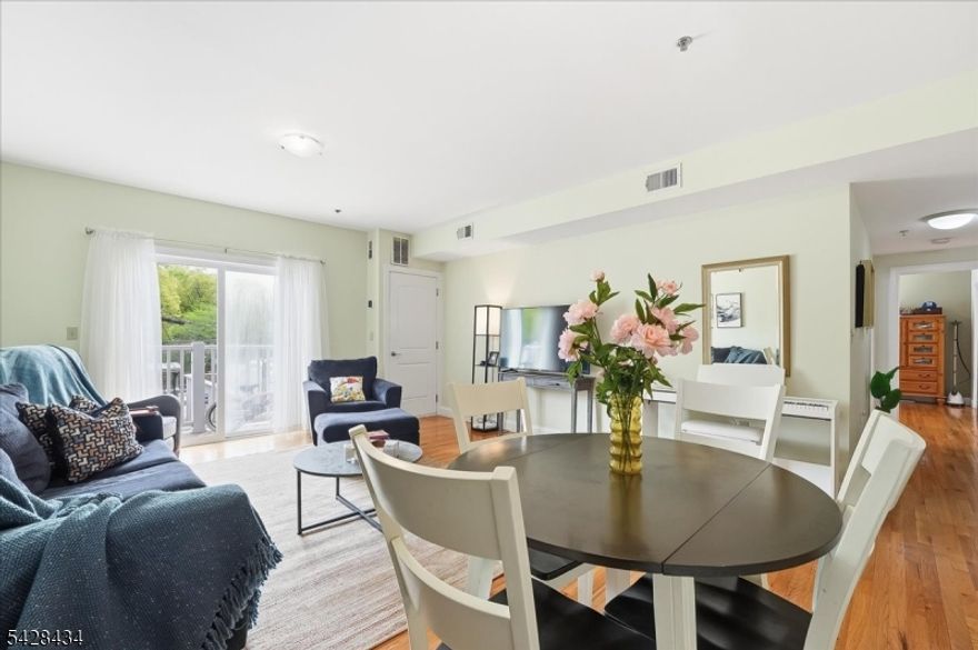 Experience the perfect blend of modern convenience and urban tranquility in this expansive 1,171 square foot residence at Branch Brook Commons. This bright and airy 2-bedroom, 2-bathroom home features a sprawling open-concept living and dining area highlighted by gleaming hardwood floors and a private balcony perfect for outdoor relaxation. The chef?s kitchen comes fully equipped with a suite of stainless steel appliances, premium countertops, and ample custom cabinetry. Retreat to a spacious primary suite boasting a massive walk-in closet and a private en-suite bathroom with a soaking tub and contemporary finishes. The versatile second bedroom is ideally situated for a home office or guest room, located just across from the second full bathroom. In-unit laundry and central heating and cooling ensure effortless daily living. Residents enjoy access to an on-site fitness center and the security of a gated, assigned parking space in a professional elevator building with intercom access and 24-hour surveillance. Located directly across the street from the Newark Light Rail, this home offers a seamless 10-minute connection to Newark Penn Station for an easy commute to Jersey City and Manhattan. You are also just steps away from the historic 360-acre Branch Brook Park, famous for its scenic trails and world-class cherry blossom collection. This move-in-ready condo offers a rare combination of space, security, and unbeatable transit access.