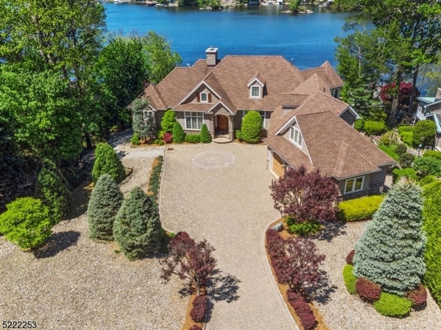 Custom lake house designed with extraordinary details. Flowing open floor plan begins at the formal entry and opens to great rm with stone gas fireplace. The formal dining rm is accented with a tray ceiling. Gleaming hardwood flooring leads you to the gourmet Kitchen. Solid wood cabinetry, commercial grade stainless appliances. Coffered ceilings add drama and detail over the dual center Islands. Enjoy the three season room off the kitchen for casual dining. A luxury 1st floor primary suite with two walk-in closets and a full bath with standing porcelain soaking tub, walk-in shower for two all accented with stone and wood tile. 2nd bedroom offers a full en-suite on a private 2nd floor level. Two additional full bedroom ensuites on the finished lower level flank the family room with custom built-in bar/summer kitchen equipped with cooktop, ice maker, wine fridge, sink and handsome wood cabinetry.  A fitness center with high ceilings and a walk-in storage room with access door to outside. Step out of the family rm onto the patio and stroll down to the lakefront boat house. Two sided docking on composite decking and the finished interior of the boat house is a walk about dock. Main floor outdoor deck with motorized awning spans over 25 feet overlooking the majestic lakefront. Opportunity for an in-ground pool as this lot is .75 acres. Walk to near by CAPP beach club with sandy swim area or take a stroll over to the Main Lake Market for ice cream & sandwiches. All just 1hr to NYC!