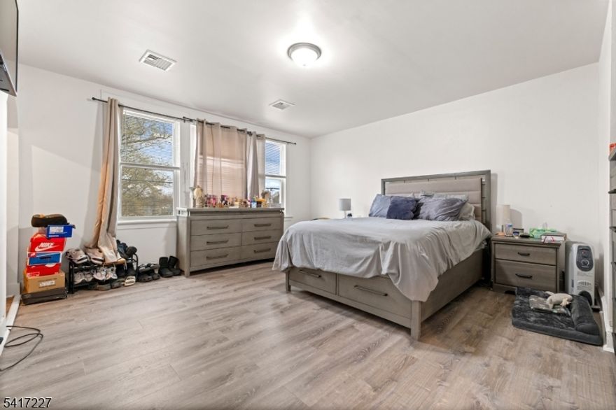 Welcome to 92 S Devine St, an exceptional two-unit property in Newark's Lower Vailsburg neighborhood boasting direct views of Vailsburg Park right across the street. Ideal for investors or owner-occupants, the second floor will be delivered vacant with the 1st floor potentially being vacant as well. Each unit offers 3 bedrooms, 1 bathroom, bright interiors, wood-look flooring, and modern kitchens with stainless steel appliances. The unfinished basement features a separate entrance, offering a great blank canvas for future renovation. Outside, enjoy a private backyard and a driveway fitting at least 3 cars. The location is an absolute commuter's dream: it is just 1 block from the NYC express bus (30 minutes to Port Authority) and a 1-minute drive to the Garden State Parkway. You are also only 15 minutes from Newark Penn Station, Newark Airport, The Mills at Jersey Gardens, and Weequahic Golf Course. Schedule a private tour today!