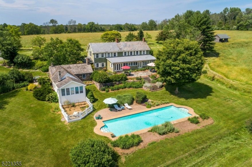 This outstanding property is ideal for those seeking privacy, tranquility and the beauty of nature. With views over the Delaware River Valley, Hidden Pond is set on a private site within 73+ acres of pasture, meadows and woodland enjoying an elevated setting with 360 degree unobstructed long distance views.  A beautiful, bright newly renovated kitchen offers walls of windows, a very large center island, glass fronted cabinets, Mexican terracotta floors, and a large eating area with French doors leading out to the terrace. There is a cozy beamed ceiling family room, formal living room with fireplace and a formal dining room. Each room features beautiful mill work, custom built-ins, and wide plank wood floors.  A huge office with a private entrance and walls of windows, a large mudroom/laundry room and full bath complete the first floor.The second floor includes the principal bedroom with vaulted ceilings and an en -suite bath with hand made tiles by a local artist.  There are an additional 2 bedrooms and a full bath. A charming one-bedroom stone guest cottage offers an open kitchen and family room with fireplace, beamed ceilings, wood floors and a large living area with walls of windows overlooking the fields and woods. The barn includes 13 box stalls, tack room, wash stall, feed room, hay loft and hot and cold water.  A beautiful 50 ft in- ground pool is surrounded by terraces and extensive hard scaping and gardens.