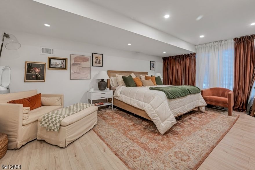 Experience ultimate luxury and convenience in this expansive, custom-built 6-bedroom, 5.5-bath Upper Montclair sanctuary, privately nestled on a tranquil cul-de-sac - just moments from the NYC direct train. Built in 1996, the main level welcomes you with a spacious living room with fireplace, an elegant dining room/family room combination ideal for gatherings, and a gourmet kitchen complemented by a separate scullery kitchen designed for seamless entertaining. A sun-drenched sunroom just off the kitchen provides the perfect setting for your morning coffee! Upstairs, you'll find 4 generously sized bedrooms, each with its own en suite bath, along with a bright, airy sitting area or home office at the top of the stairs. The lower level offers a legal, fully appointed ground-floor apartment featuring 2 bedrooms, 1 full bath, a living room, dining area, full kitchen, and it's own private entrance - ideal for guests. In the warmer months, relax and entertain outdoors with an in-ground heated pool and inviting spaces for barbecuing and lounging. This rare property blends sophisticated comfort with unbeatable access to Montclair's vibrant dining, shopping, and cultural scene! This property is NOT a part of Reservoir Ridge.  It is in Montclair and is a part of the Montclair School District.