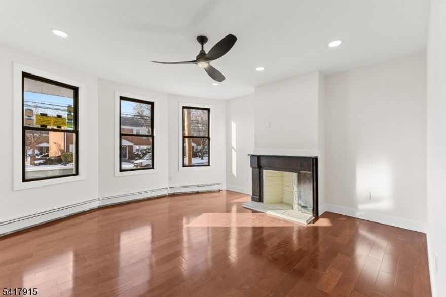 This beautifully renovated 3 Family house features three 2-bedroom, 1-bath units, each on its own floor, stylishly combining modern comfort and old-world charm. Each unit has its own electrical and gas meters, new energy-efficient windows, tile, and hardwood floors, all new appliances, including a washer/dryer in the unit, mini split a/c. ceiling fans and recessed lighting throughout.The First-floor unit w/separate entrance, 9' ceilings, a stunning new kitchen with luxurious quartz countertops, a spacious center island perfect for meal prep or casual dining, a pantry, and sleek cabinetry for ample storage.The second-floor unit also has 9' ceilings, a stunning kitchen, a washer/dryer, and front porch. The 3rd floor is slightly smaller, with a new kitchen and bath. This location offers the convenience of being close to public transportation and a vibrant downtown, making it perfect for both commuting and leisure. Don't miss the opportunity to make this upscale rental property your new home!