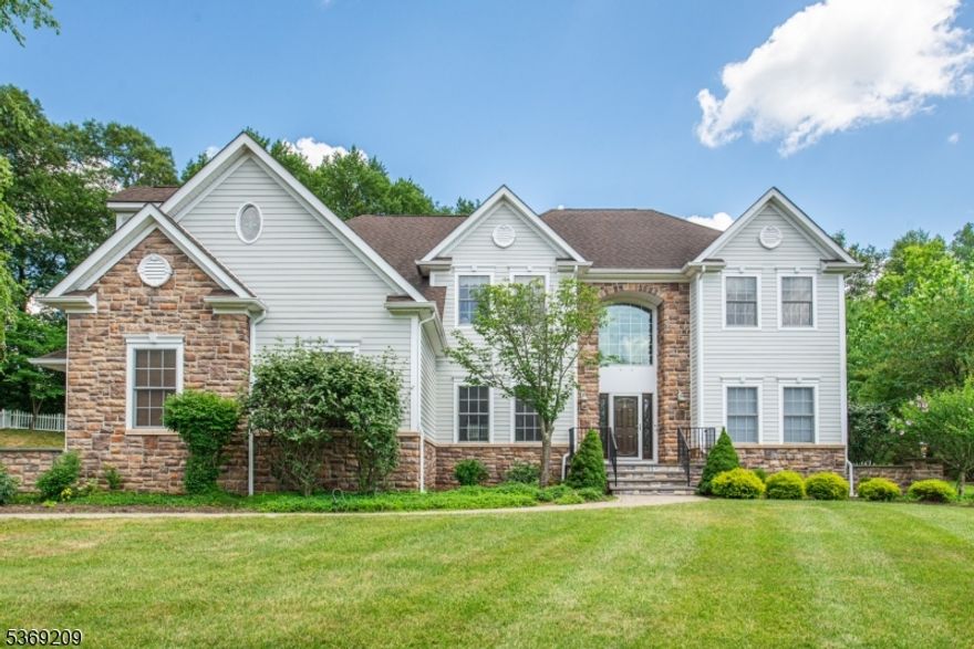 Experience luxury in this beautifully updated custom colonial, located on a private 0.9-acre lot at the end of a quiet cul-de-sac in Succasunna. Freshly painted inside and out, this meticulously maintained 4-bedroom, 2.5-bath home offers an open floor plan with hardwood floors, elegant moldings, and abundant natural light. The recently renovated kitchen features quartz countertops, stainless steel appliances, custom cabinetry, and a large island, flowing into the dining and family rooms ideal for entertaining. The vaulted family room includes a gas fireplace, and a private home office provides added flexibility. Upstairs, the spacious primary suite includes a spa-like bath, three walk-in closets, a fourth closet, and a sitting room perfect as a retreat or second office. A second-floor laundry room offers easy access to a full walk-up attic. The partially finished basement adds flexible space for recreation, while still allowing plenty of room for storage. Enjoy your private backyard oasis with a Trex deck, Sundance hot tub, and custom gunite in-ground pool. Pool heater replaced in 2020. Additional features include pool cover, and equipment, new hot water heater, Pella windows and doors, and public utilities. Minutes to Routes 10, 46, 80 & 206, shopping, dining, and top-rated Roxbury schools.