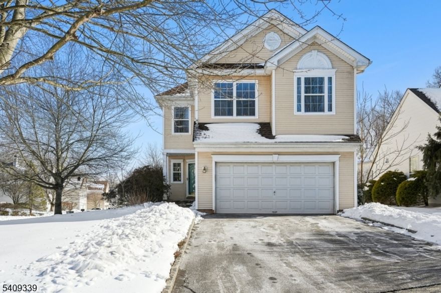 Set on a corner lot at the start of a cul-de-sac in the Lake Cushetunk community, this 4-bedroom, 2.5-bath home offers a well-balanced mix of space, natural light, and thoughtful updates. Hardwood flooring runs throughout much of the home, and many rooms have been freshly painted, creating a bright, refreshed feel.The family room serves as the central gathering space, featuring a wood burning fireplace and an easy flow into the kitchen and dining areas, ideal for everyday living and entertaining. Large windows throughout the home bring in abundant natural light, enhancing the open feel of the living spaces. The fully finished basement adds valuable flexibility for whatever fits your needs. The primary suite is a standout, featuring cathedral ceilings and oversized windows. The updated primary bathroom includes modern finishes, and custom closet shelving provides smart, organized storage. Additional bedrooms offer comfortable proportions and versatility for a variety of needs.Outdoor living is extended by a deck with awning, creating a comfortable setting for dining or relaxing during warmer months.Lake Cushetunk is appreciated for its scenic surroundings, with nearby access to walking paths. This community offers a peaceful backdrop while remaining close to daily conveniences.Conveniently located minutes from Routes 22, 287, and 78, the Whitehouse train station, and a wide range of shopping and dining options, this home offers both accessibility and a connected lifestyle.