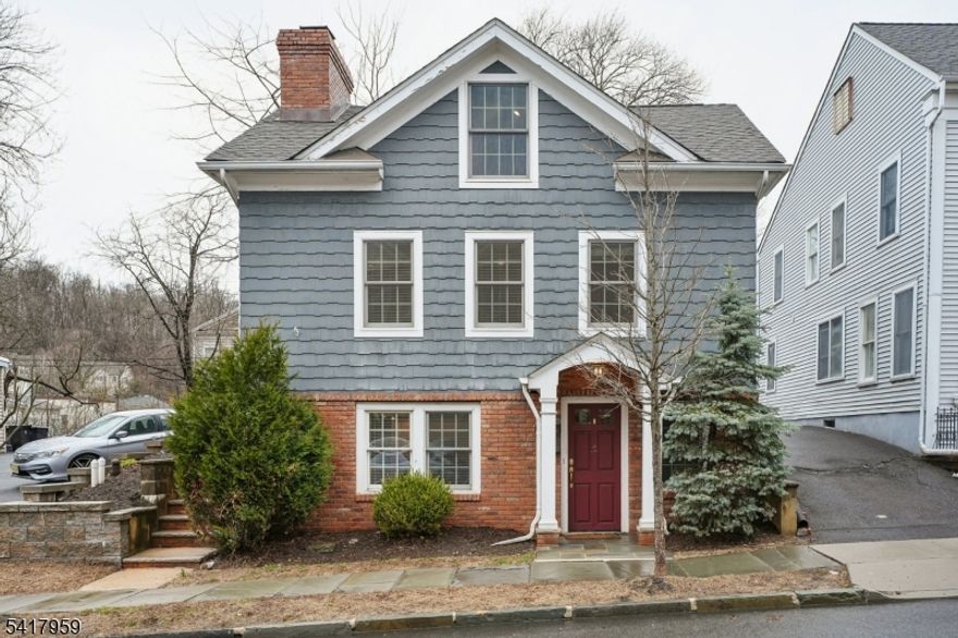 Built in 1890, this charming Victorian row house blends historic character with modern updates in the heart of downtown Morristown. Just blocks from the Green, train, restaurants, and shops, enjoy exceptional walkability and vibrant in-town living. The main living level offers a flexible, open floor plan for today's lifestyle, featuring hardwood floors, recessed lighting, crown molding, a wet bar with a mini-fridge, and a striking exposed-brick fireplace with built-ins. Elegant columns & shelving add character while maintaining an inviting flow for everyday living and entertaining. The eat-in kitchen, located on the "garden level,  features granite countertops and ample workspace with room for a center island or bistro set. This level also includes laundry and mechanicals, reflecting the home's original late-19th-century design. Upstairs are two sun-filled bedrooms and a full bath. Taken down to the studs and renovated by W P Lloyd Custom Building, the home retains its charm and character while showing like new construction. Enjoy a private deck and level yard, plus a storage shed. Resident permit parking is conveniently out front, and the DeHart Street Garage is just half a block away. An affordable alternative to Morristown's townhouse &  condo market, offering rare in-town convenience. Whether it's a morning stroll to the Farmers Market, Morristown's Fall Festival, or spending a day at JazzFest on the Green, this is truly a new and exciting lifestyle opportunity.