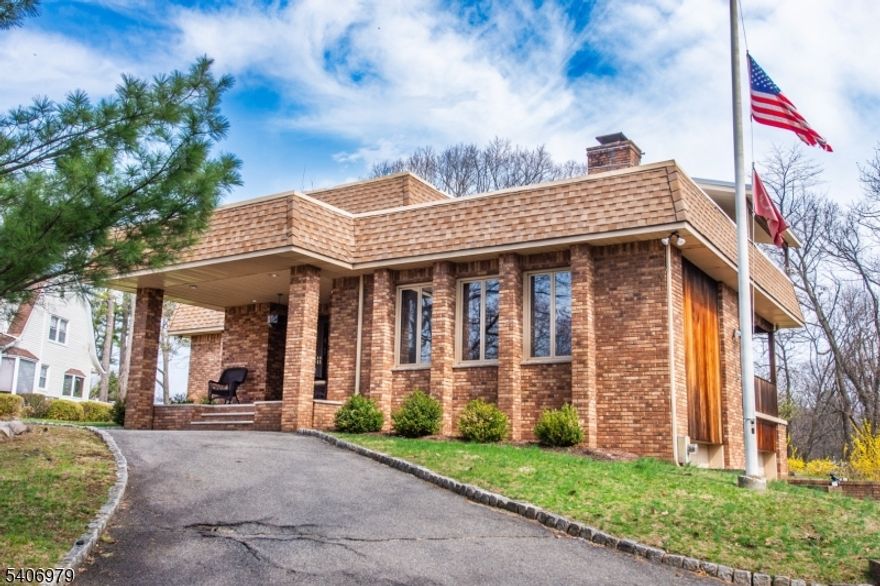 Custom Colonial on a very private cul-de-sac in one of the most desirable locations in Woodland Park. Welcome home! Features include: Astunning open floor plan with an impressive 2 entry foyer and a formal living room with vaulted ceilings, beautiful stone fireplace all opens to a formal diningroom & a large family room with a fireplace. Large kitchen with granite counter tops, stainless-steel appliances, center island & breakfast room. Sliding glassdoors lead out to the sun-filled four-season room with walls of windows and cathedral ceilings, perfect for entertaining or relaxing while enjoying views of theexpansive yard. Conveniently located first floor powder room & laundry room. Second floor includes: primary suite with walk-in closets & generousbathroom. Additional 2 spacious bedrooms with full shared bathroom. On the lower level there is plenty of storage and finished areas. Additional highlightsinclude: circular driveway with impressive covered front porch, sizable 2 car attached garage, outdoor balconies, quality construction with brick exterior,recessed lighting, well maintained, lots of natural light, contemporary styling, & hardwood floors. Enjoy the outdoors- resort style living, wonderful privatebackyard with patios, beautiful views, and a saltwater pool with a new liner - your own private retreat. Conveniently located minutes from major highways,shopping, restaurants, major highways, NJ Transit public transportation, community parks, & New York City.