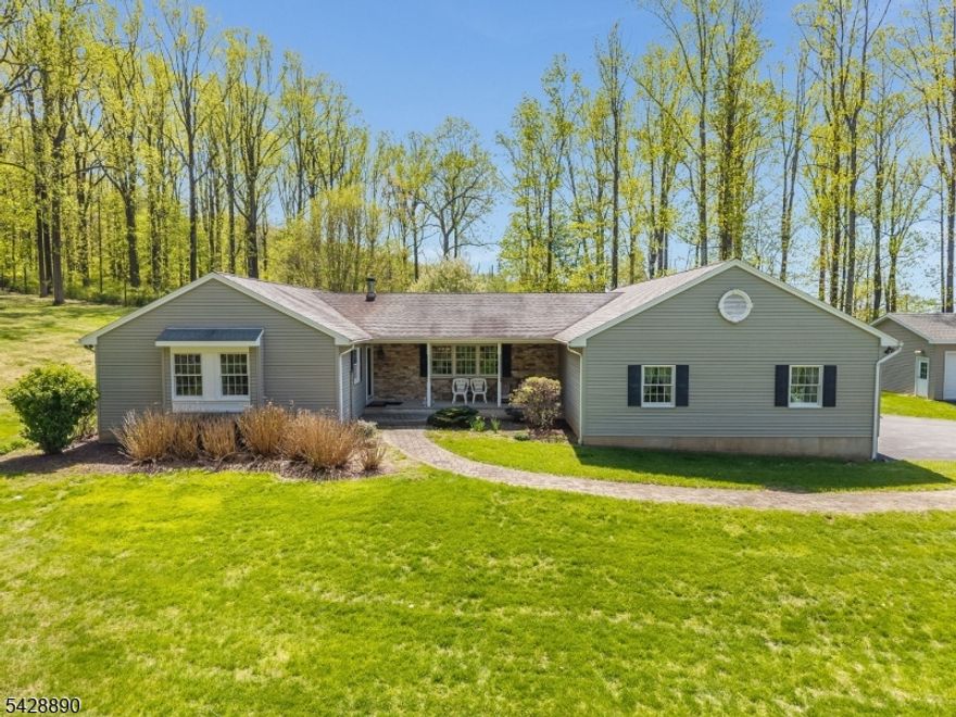 Welcome to country living at its finest! Tucked away from the road on a private 3+ acre lot, this custom ranch offers space, privacy, & thoughtful design throughout. The home features 3 bedrooms & 2.5 baths, including a spacious living room highlighted by a beautiful stone gas fireplace?perfect for cozy nights at home. The kitchen offers an abundance of counter space &  cabinetry to meet all your storage needs & flows seamlessly into the family room, formal dining room & living room, an ideal layout for everyday living & entertaining. Just off the kitchen, the sun room provides the perfect spot to enjoy all 4 seasons. 2 generously sized bedrooms feature charming window seats, ample closet space, & share a full hall bath. The primary suite is a boasts two walk-in closets & bath with double sinks, a soaking tub, & a separate shower. A first-floor laundry room & convenient half bath complete the main level. Add'l highlights include a attached three-car garage with direct access to a full walk-out basement, offering endless possibilities for finishing and plenty of space for a workshop. Need even more room? A detached 2 car garage is an added bonus?perfect for hobbyists or extra storage. The fenced yard offers privacy & space for gardening, flowers, or outdoor enjoyment. A whole-house generator provides peace of mind, ensuring you?re never without power.