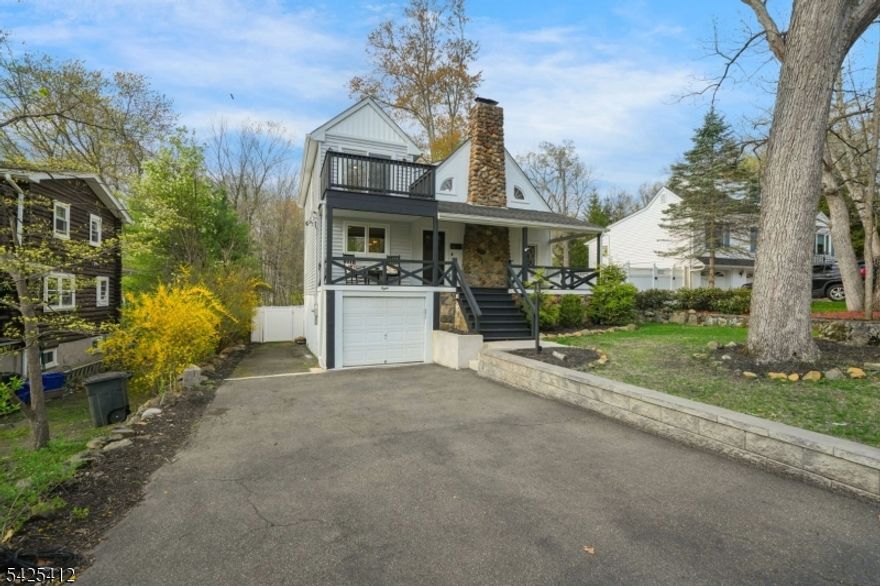 Welcome to this beautifully renovated home in the sought-after Packanack Lake community of Wayne. Thoughtfully updated in 2022, this 4-bedroom, 2.5-bath home offers approx. 2,277 sq ft of versatile living space with a move-in ready feel.The heart of the home is the renovated kitchen featuring a quartz center island, modern finishes, and seamless flow into the dining and living areas, ideal for both everyday living and entertaining. A first-floor primary suite with an updated full bath adds convenience and flexibility.Upstairs, you'll find three additional bedrooms, a full bath with dual sinks, and access to a private balcony. Enjoy seasonal lake views from both the charming front porch and second level, adding to the home's unique appeal.The finished lower level provides additional space for recreation, a home office, or flexible use, along with laundry, storage, and garage access. Outdoor living includes a rear deck and patio for relaxing or entertaining. Smart features include Nest thermostats, Lutron lighting, Ring doorbell, and keyless entry. 2-car tandem garage, opener, Tesla EV charger. Located just moments from Packanack Lake, enjoy access to private beaches, clubhouse, & year-round community events. Optional golf and tennis memberships available. Wayne offers top-rated schools, parks, shopping, dining, and convenient access to major highways & NYC transportation.A perfect blend of charm, updates, and lifestyle. Don't miss this opportunity.